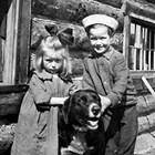 Crawford children Bertha and Leroy and dog at their home in Anchorage, 1920.