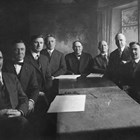 The first city council after incorporation, 1920, together with the city's clerk, attorney, and engineer.  Michael Conroy is fourth from the left.  Conroy was city clerk, the highest paid city employee with wide-ranging responsibilities.  Mayor Leopold David is in the center of the photograph.