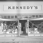 A view of Kennedy’s clothing store with patriotic decorations, possibly to celebrate Washington and Lincoln’s birthday or the 4th of July.  The photograph was taken some time after James Kennedy’s death in 1934, after his brother and partner Daniel moved the store across 4th Avenue to this location.