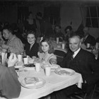 James Delaney, his wife Nancy, and one of their two daughters at a dinner and dance in the Army Recreational Hall at Fort Richardson on January 13, 1945.